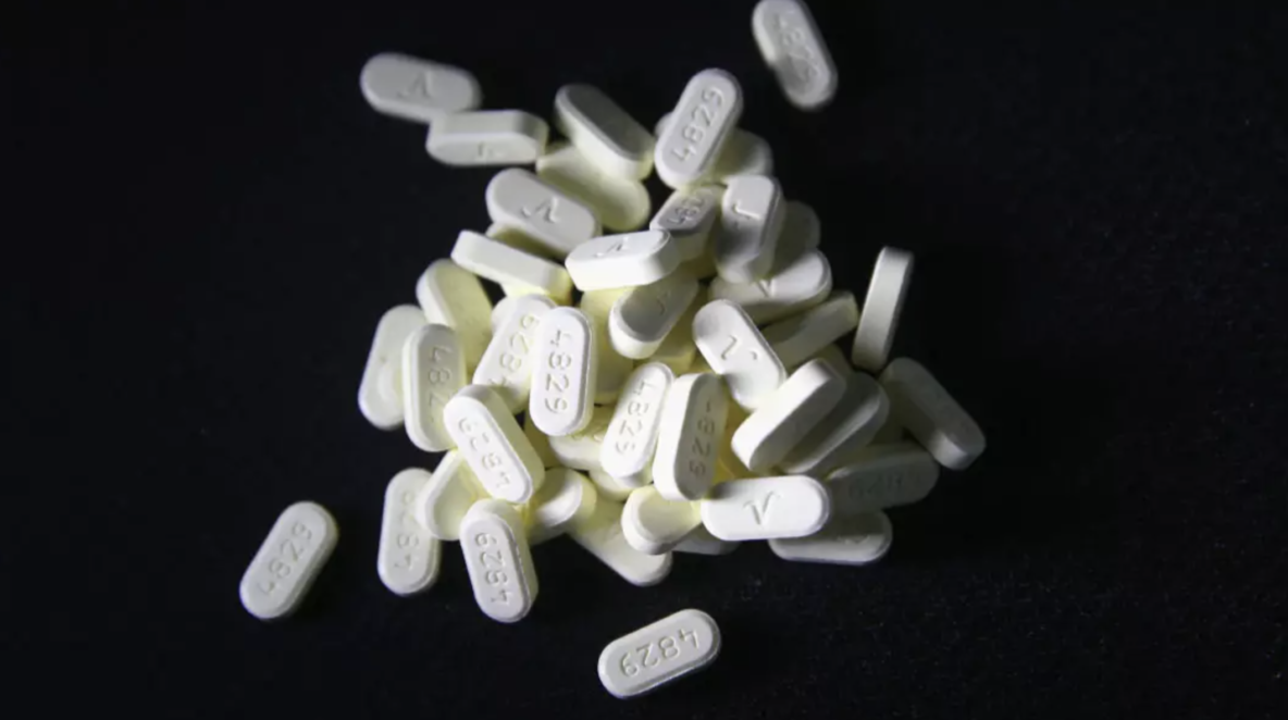 White pills on a black background