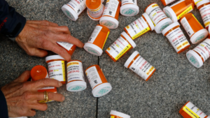Prescription Opioid bottles litter a street