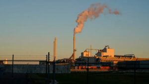 A view of the Gopher lead factory with smoke rising at sunset.